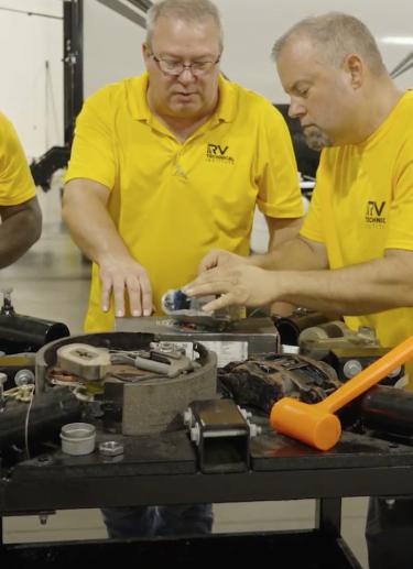 Group of technicians working on an RV part