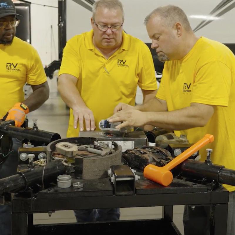 Group of technicians working on an RV part
